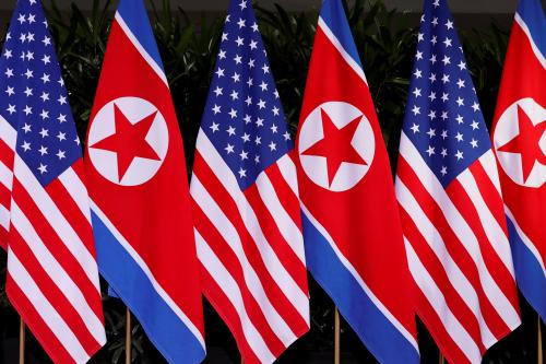 U.S. and North Korean national flags are seen during the meeting of U.S. President Donald Trump and North Korean leader Kim Jong Un at the Capella Hotel on Sentosa island in Singapore June 12, 2018. REUTERS/Jonathan Ernst - RC1C1F358640