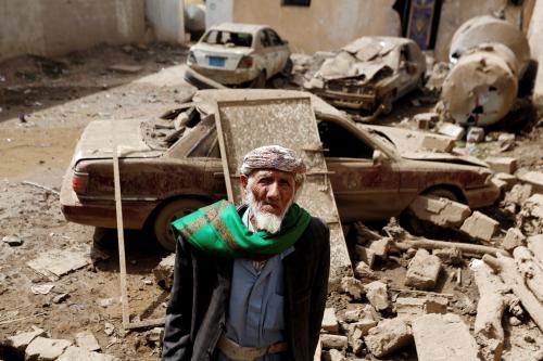 A man stands next to cars damaged by an air strike in Amran, Yemen June 25, 2018. REUTERS/Khaled Abdullah     TPX IMAGES OF THE DAY - RC1FAE9C8CC0