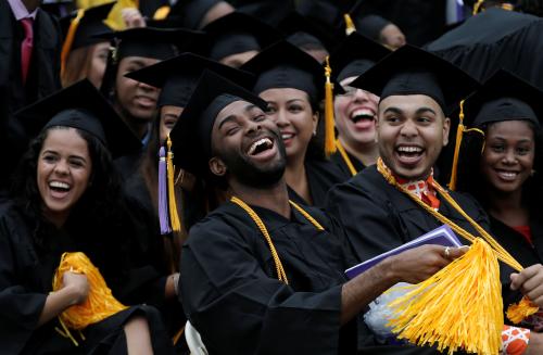 Graduating students of the City College of New York laugh together during the College's commencement ceremony in the Harlem section of Manhattan, New York, U.S., June 3, 2016. REUTERS/Mike Segar - D1BETHVBPRAA