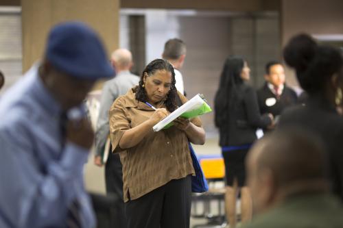 Malana Long fills out a job application during a job fair for the homeless at the Los Angeles Mission in the Skid Row area of Los Angeles, California, in this file photo taken June 4, 2015. The number of Americans filing new claims for unemployment benefits fell more than expected last week, pointing to a tightening labor market.   REUTERS/David McNew/Files - TM3EB6I0O4101