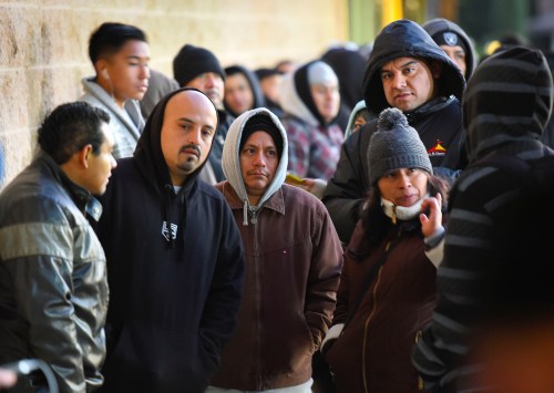 People wait in line at the California Department of Motor Vehicles in Granada Hills January 2, 2015. The California Department of Motor Vehicles on Friday begin issuing driver licenses under AB 60, the new law requiring DMV to issue a driver license to applicants regardless of immigration status in Los Angeles. REUTERS/Gus Ruelas (UNITED STATES - Tags: TRANSPORT POLITICS LAW) - GM1EB121UEN01