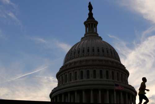 A jogger runs past The U.S. Capitol Building at sunset in Washington, U.S. May 17, 2017. REUTERS/Zach Gibson     TPX IMAGES OF THE DAY - RC12D17B9D10