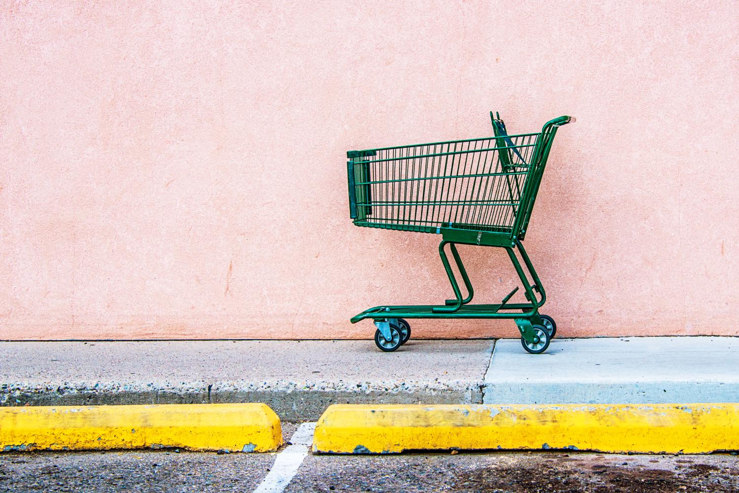 Abandoned Shopping Cart against Pink Wall
