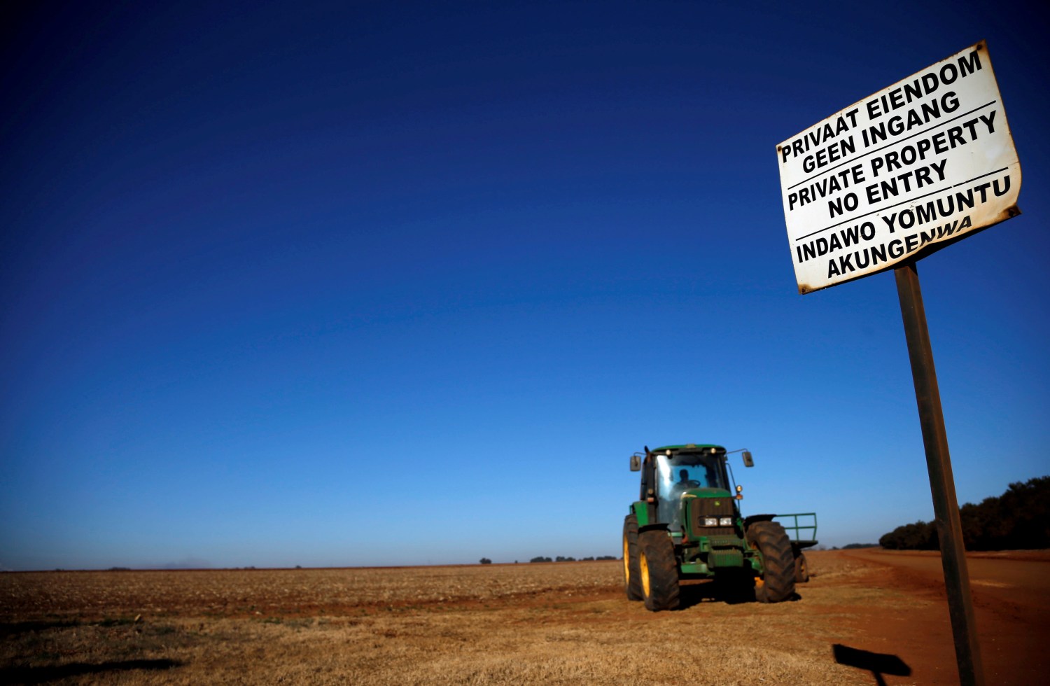 FILE PHOTO: A 'No entry sign' is seen at an entrance of a farm outside Witbank, Mpumalanga province, South Africa July 13, 2018. REUTERS/Siphiwe Sibeko/File Photo - RC1F780A9920