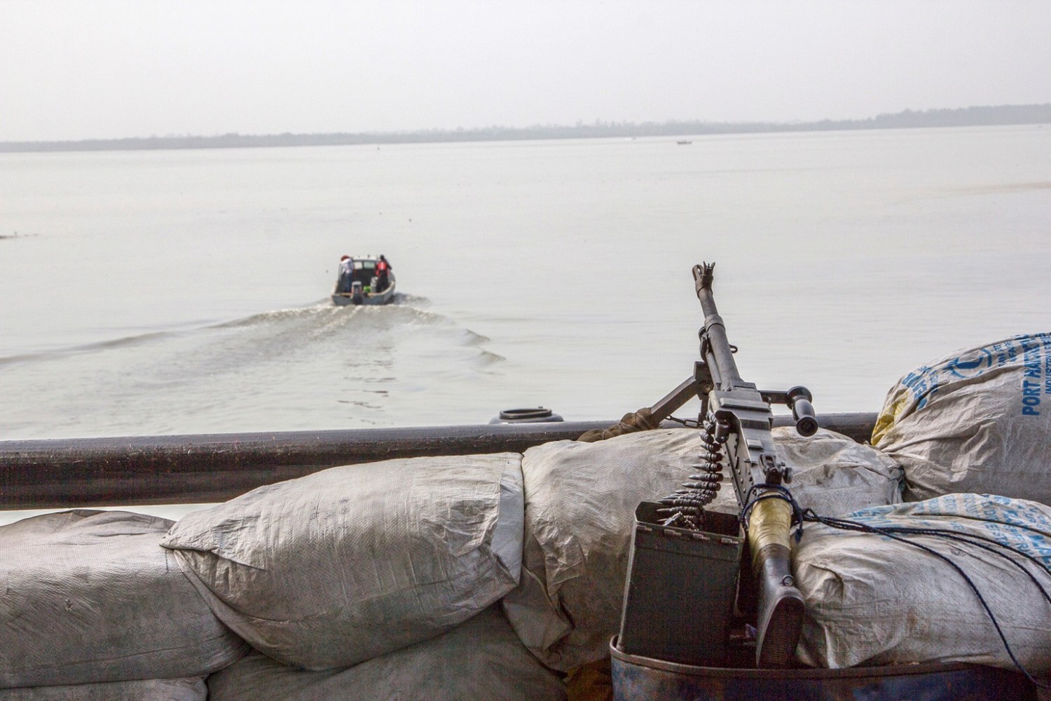 A machine gun is seen on a sandbag on a boat off the Atlantic coast in Nigeria's Bayelsa state December 19, 2013. REUTERS/Stringer/File Photo - D1AETBYATEAC