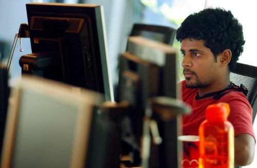 A researcher works on his terminal at the Microsoft India research centre in Bangalore June 24, 2009. Staffed with about 60 full-time researchers, many of them Indians with PhDs from top universities in the United States, the centre is at the cutting edge of Microsoft's R&D. It covers seven areas of research including mobility and cryptography. Its success, including developing a popular tool for Microsoft's new search engine Bing, underscores the potential of R&D in India at a time when cost-conscious firms are keen to offshore to save money by using talented researchers abroad.  To match feature INDIA-R&D/ REUTERS/Punit Paranjpe (INDIA SCI TECH BUSINESS) - GM1E57L0LK701