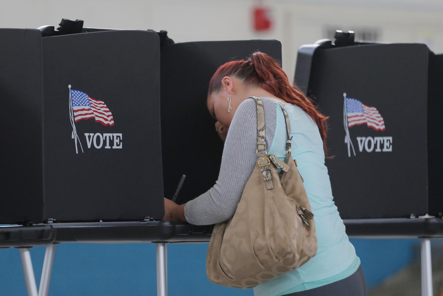 Melissa Foye fills out her ballot as she votes in the U.S. presidential election at the National Guard Armory in Smithfield, North Carolina, U.S. November 8, 2016. REUTERS/Chris Keane - HT1ECB81E4Y70