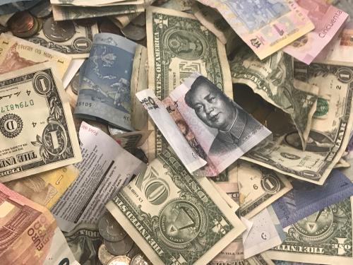 U.S. dollars and other world currencies lie in a charity receptacle at Pearson international airport in Toronto, Ontario, Canada June 13, 2018. REUTERS/Chris Helgren - RC1CEFA03510