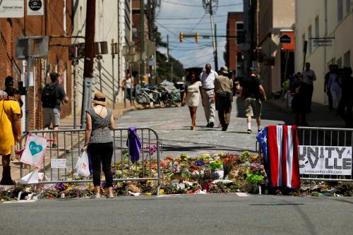 People visit the makeshift memorial to car attack victim Heather Heyer in Charlottesville, Virginia, U.S. August 18, 2017.  REUTERS/Jonathan Ernst - RC1D3A3DD0D0
