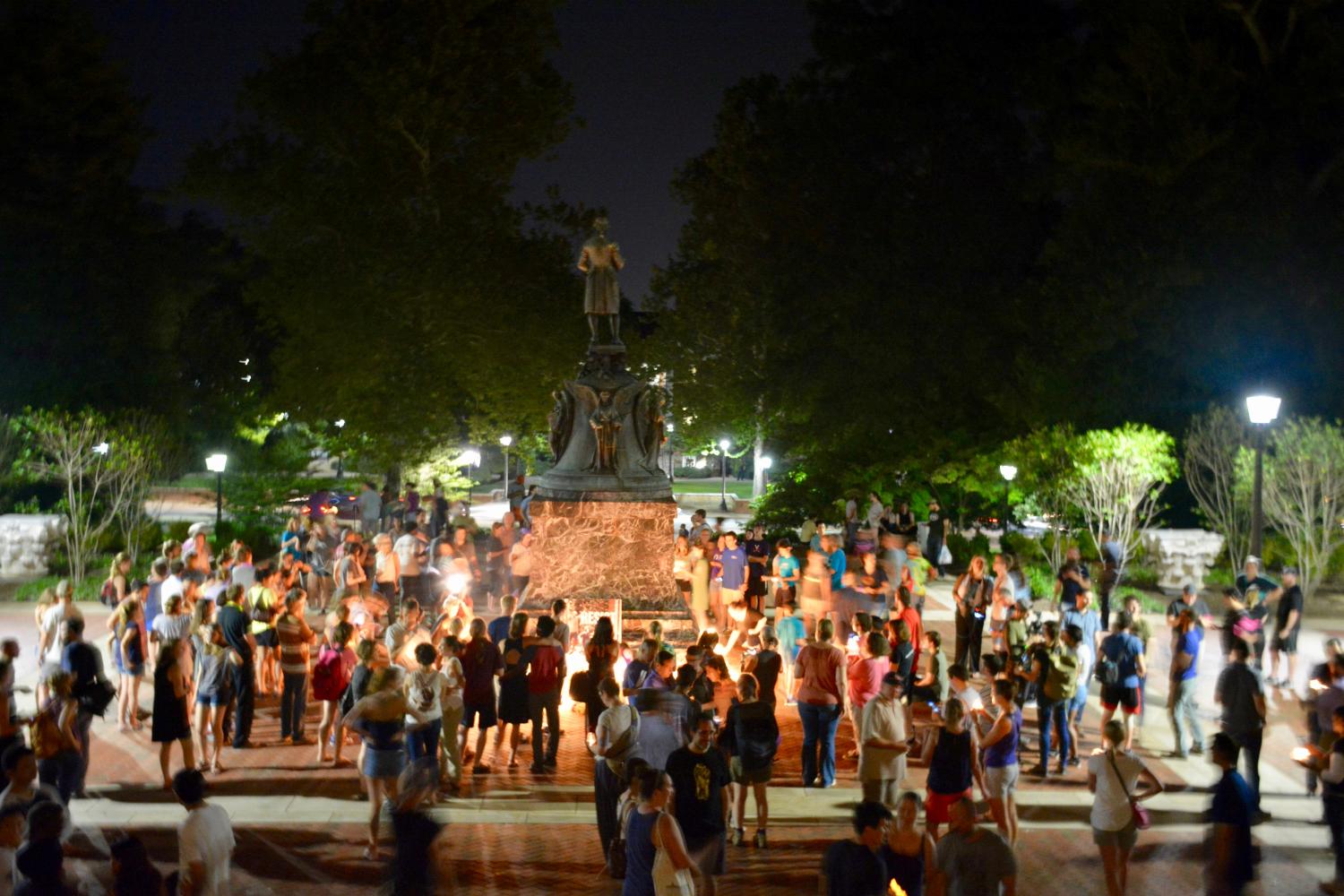 Charlottesville community members leave candles and flowers at the base of a statue of Thomas Jefferson north of University of Virginia's Rotunda at a vigil for Heather Heyer following last Saturday's protest organized by white nationalists that turned deadly in Charlottesville, Virginia, U.S. on August 16, 2017. Picture taken on August 16, 2017.   Courtesy Tim Dodson/The Cavalier Daily/Handout via REUTERS   ATTENTION EDITORS - THIS IMAGE WAS PROVIDED BY A THIRD PARTY. MANDATORY CREDIT. - RC161271C8B0