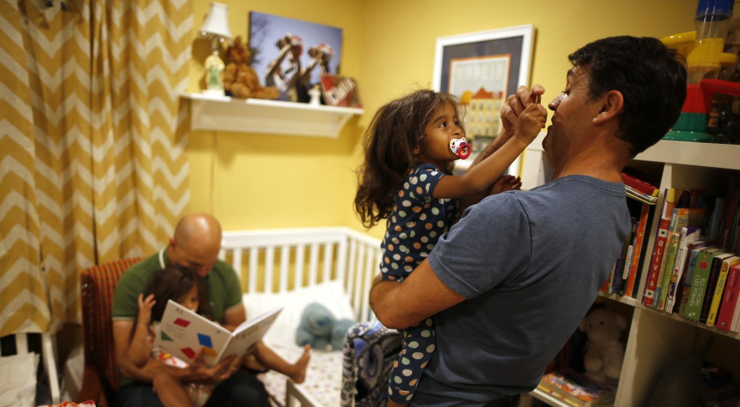 A father, his husband, and their daughters at their home in Los Angeles.