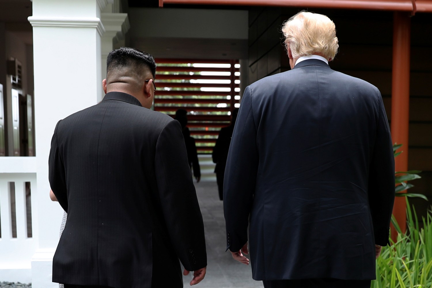 U.S. President Donald Trump and North Korea's leader Kim Jong Un walk together before their working lunch during their summit at the Capella Hotel on the resort island of Sentosa, Singapore June 12, 2018. Picture taken June 12, 2018. REUTERS/Jonathan Ernst
