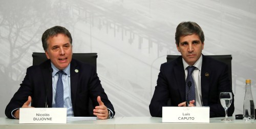 Argentina's Treasury Minister Nicolas Dujovne speaks next to Central Bank President Luis Caputo