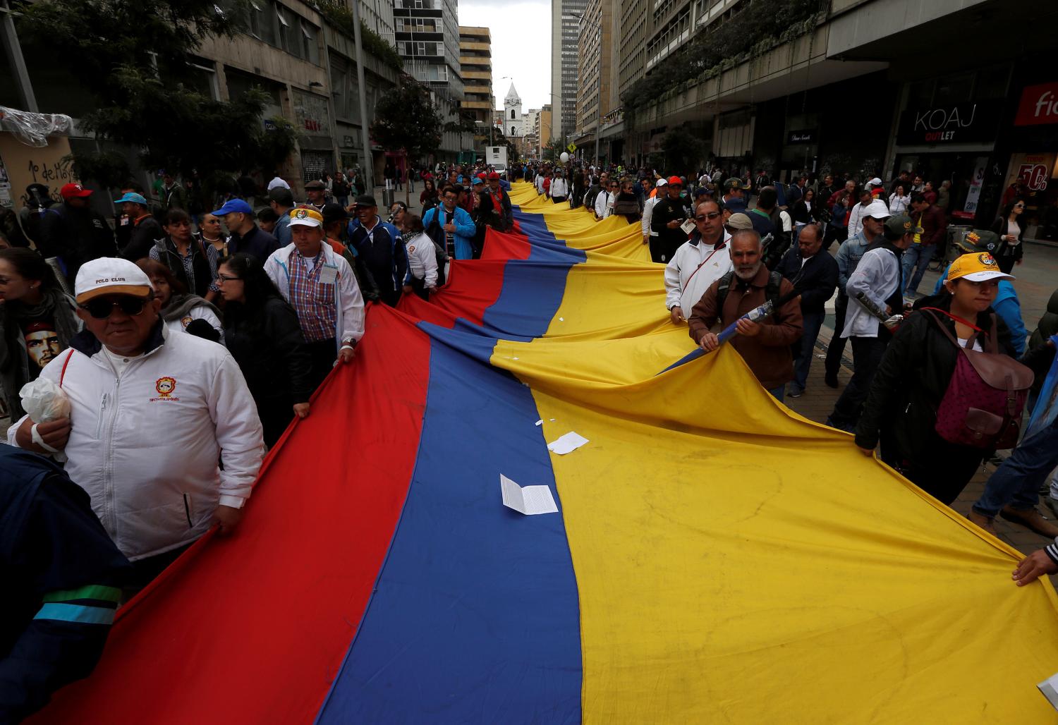 Demonstrators hold a flag during a rally commemorating May Day in Bogota, Colombia May 1, 2018. REUTERS/Jaime Saldarriaga - RC163BBBBF30