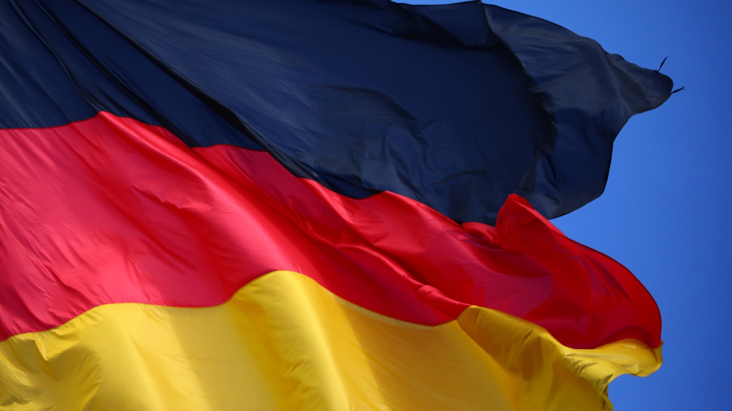 A German flag flutters in Berlin, Germany, July 2, 2018. REUTERS/Hannibal Hanschke - RC16DEB12D50