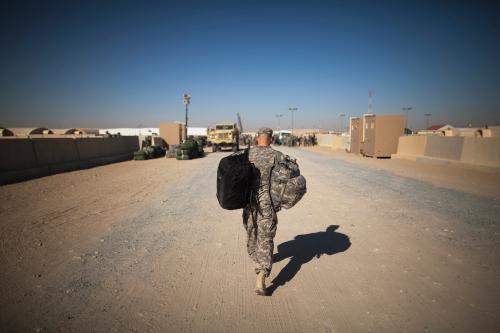 A soldier from the 3rd Brigade, 1st Cavalry Division carries his bag to begin his trip back to the United States at Camp Virginia, Kuwait December 20, 2011. The 3rd Brigade, 1st Cavalry Division was the last U.S. Military unit to depart Iraq and is processing to return to Fort Hood, Texas. REUTERS/Lucas Jackson (KUWAIT - Tags: MILITARY POLITICS TPX IMAGES OF THE DAY) - GM1E7CK1RQT01