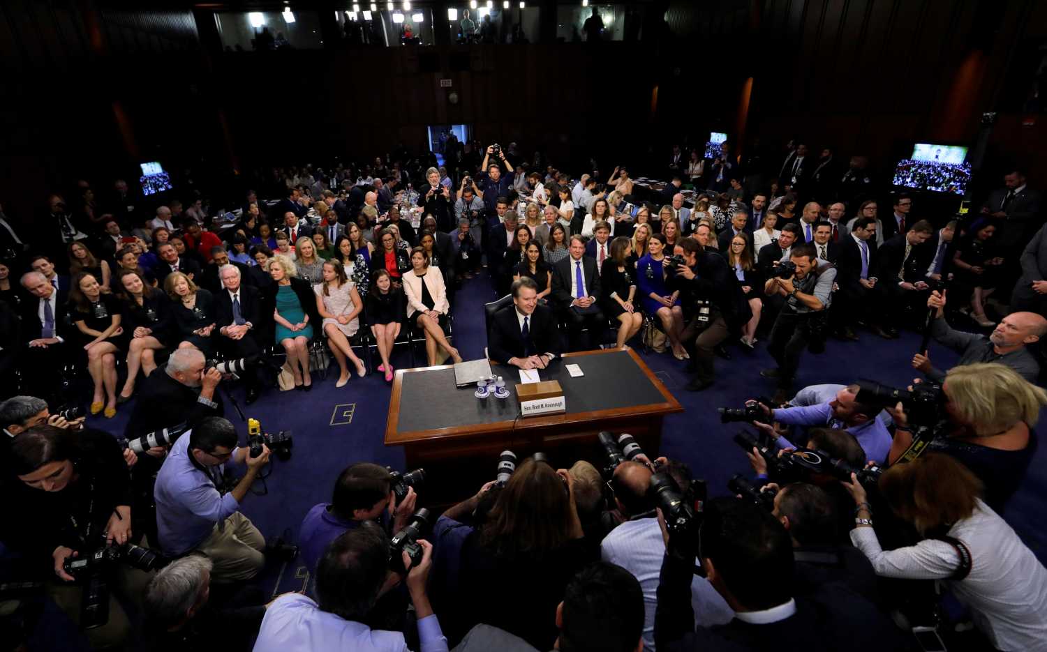 U.S. Supreme Court nominee judge Brett Kavanaugh is surrounded by photographers as he takes his seat for his Senate Judiciary Committee confirmation hearing on Capitol Hill in Washington, U.S., September 4, 2018. REUTERS/Jim Bourg - RC1A13F42AB0