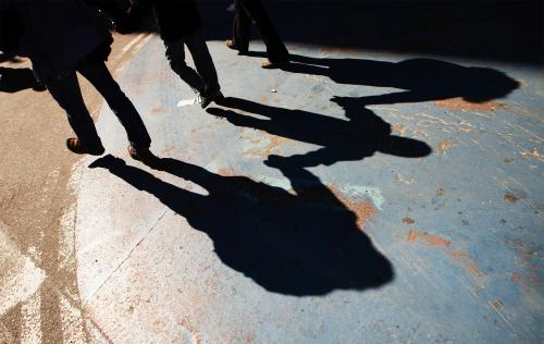 A family hold hands as they walk through Times Square during a warm winter day in New York March 6, 2012. REUTERS/Lucas Jackson (UNITED STATES - Tags: ENVIRONMENT SOCIETY) - GM1E8370EKC01