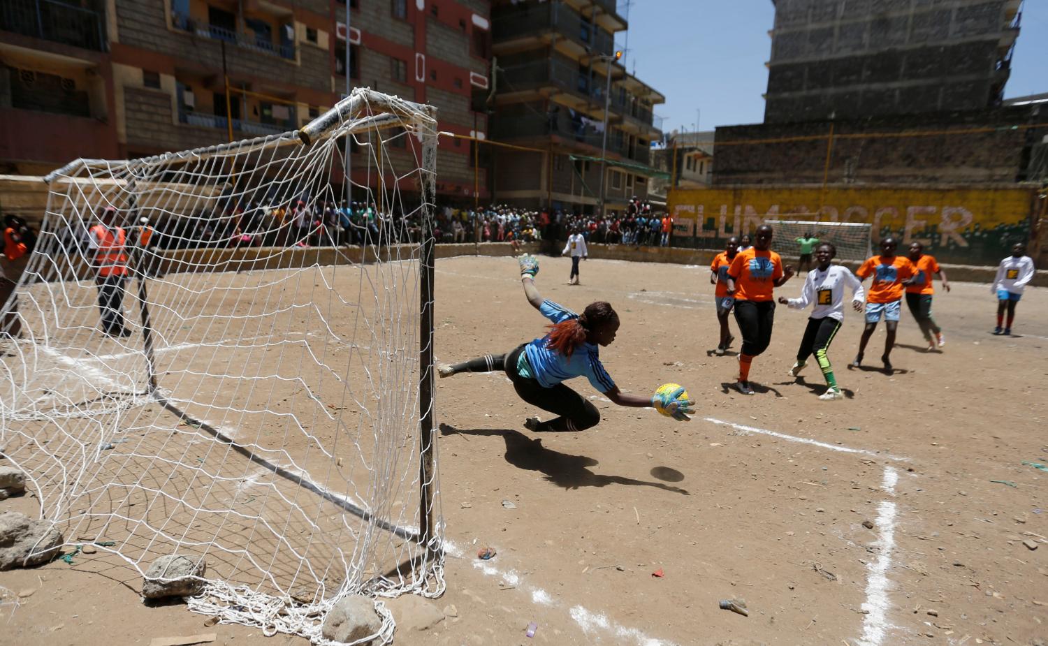 A female goalkeeper saves the ball at the Mathare Environmental Conservation Youth Centre during a soccer match to celebrate the International Women's day in Nairobi, Kenya, March 8, 2017. REUTERS/Thomas Mukoya - RC1A35B15000
