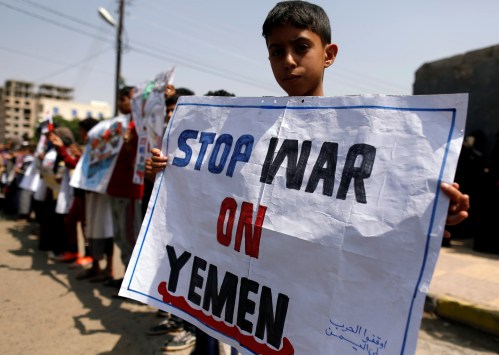 A boy holds a placard as he demonstrates outside the offices of the United Nations in Sanaa, Yemen to denounce last week's air strike that killed dozens including children in the northwestern province of Saada, August 13, 2018. REUTERS/Khaled Abdullah - RC169E24A380