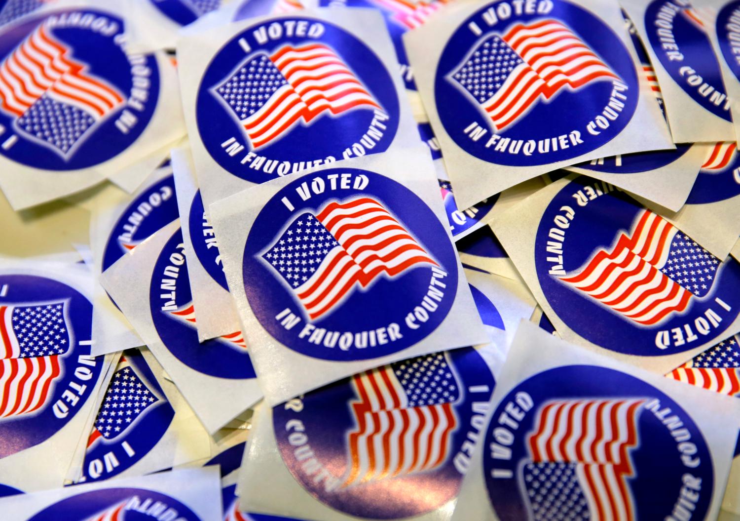 "I voted" stickers are on display for voters in the U.S. presidential election at Grace Episcopal Church in The Plains, Virginia, U.S., November 8, 2016.      REUTERS/Joshua Roberts - HT1ECB8183K3O