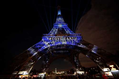 The Eiffel Tower is lit with blue lights as part of the events in the French capital to mark the World Climate Change Conference 2015 (COP21), in Paris, France, December 2, 2015.   REUTERS/Eric Gaillard  - LR2EBC21EP3JD