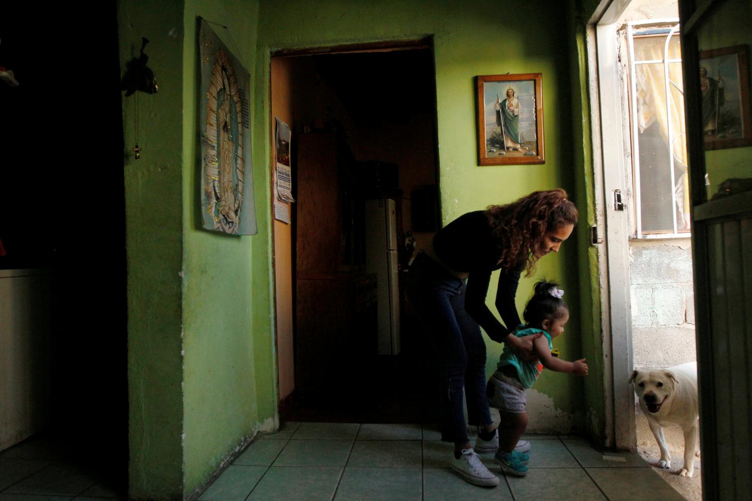 Fatima Paola Pizarro (L), holds her daughter Aitana Pizarro at her grandparent's home in Ciudad Juarez, Mexico May 8, 2018. Fatima is the daughter of Marcelino Pizarro who lives in El Paso, U.S. REUTERS/Jose Luis Gonzalez   SEARCH "MARCELINO PIZARRO" FOR THIS STORY. SEARCH "WIDER IMAGE" FOR ALL STORIES. - RC1EC57A0B00
