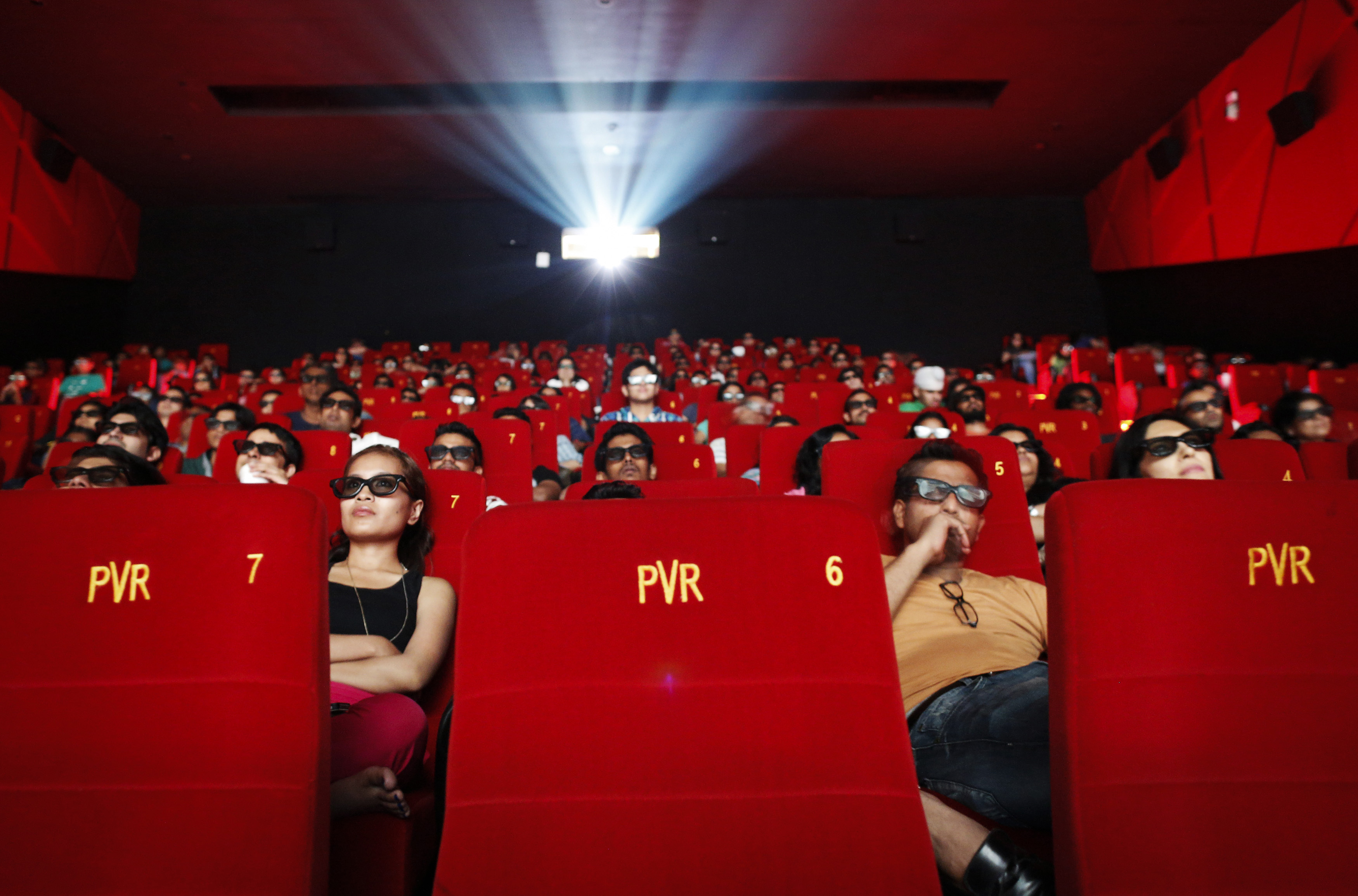 Cinema-goers wearing 3D glasses watch a movie at a PVR Multiplex in Mumbai November 10, 2013. Multiplex operators like PVR Ltd, Inox Leisure, Reliance Mediaworks and Mexican chain Cinepolis are scrambling to set up theatres targeting the rapidly growing number of middle-class Indians willing to pay to watch Bollywood movies in more comfortable surroundings. The potential is huge, provided operators can find the right location in a country where prime urban real estate is costly and in short supply. Picture taken November 10, 2013.       To match MULTIPLEX-INDIA/        REUTERS/Danish Siddiqui (INDIA - Tags: SOCIETY BUSINESS ENTERTAINMENT) - GM1E9BK0DED01