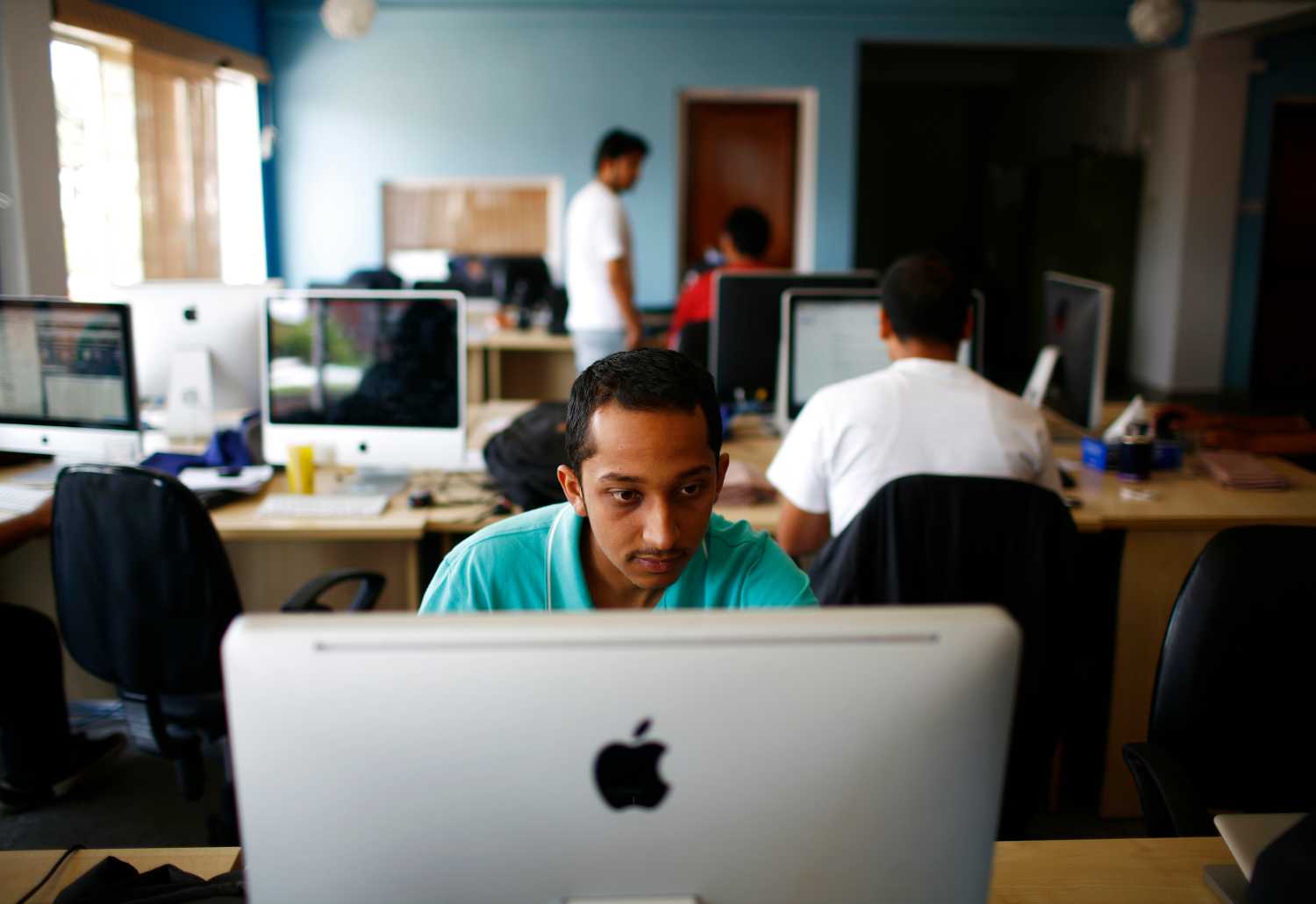 An employee works on his computer at an office in Kathmandu, Nepal