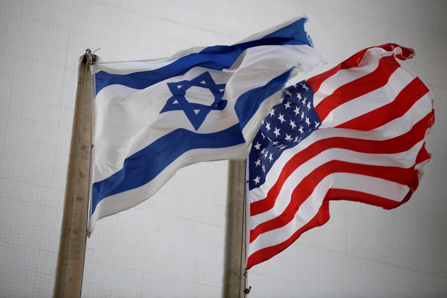 The American and the Israeli national flags can be seen outside the U.S Embassy in Tel Aviv, Israel December 5, 2017. REUTERS/Amir Cohen - RC12C5C0CBF0