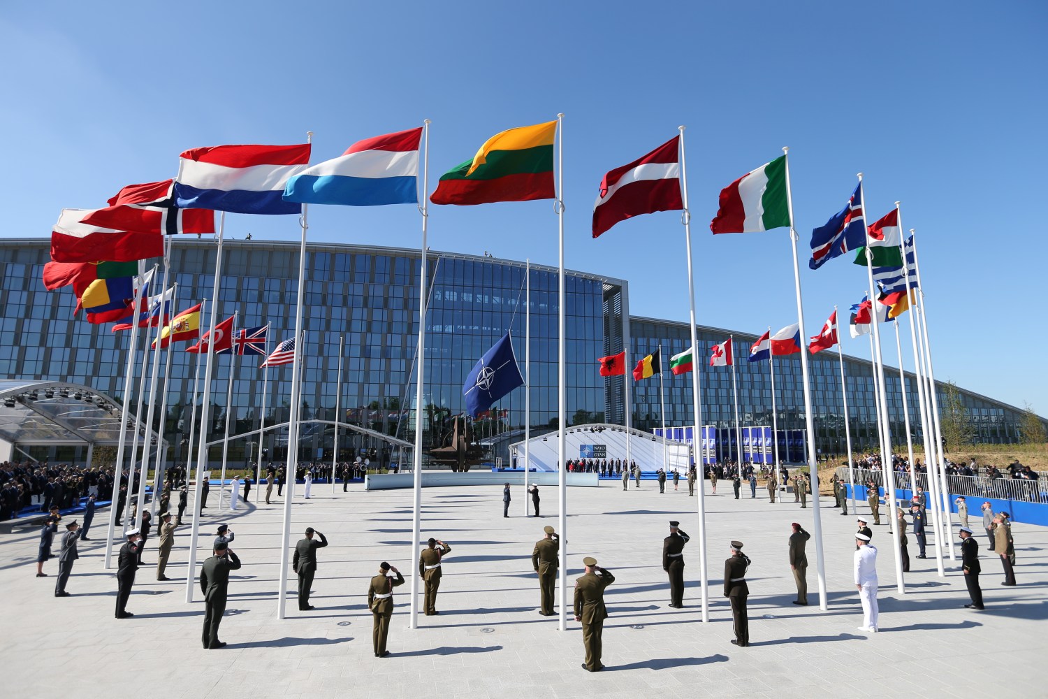 Flags of NATO member countires fly during a ceremony at the new NATO headquarters before the start of a summit in Brussels, Belgium, May 25, 2017.    REUTERS/Christian Hartmann - RC1AE63D1910