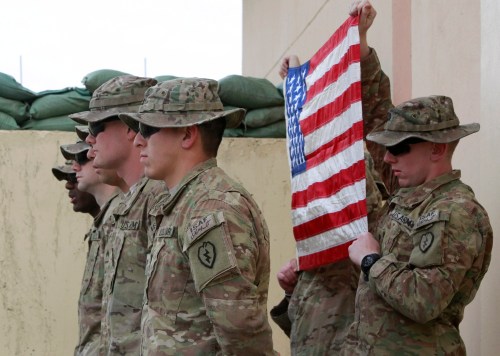 U.S. Army soldiers from Bravo Company, 2nd Battalion, 35th Infantry Division, Task Force Cacti take part in a military re-enlistment ceremony at Forward Operating Base Joyce in Kunar province, eastern Afghanistan March 13, 2012.   REUTERS/Erik De Castro (AFGHANISTAN - Tags: POLITICS MILITARY CIVIL UNREST) - GM1E83D19GV01