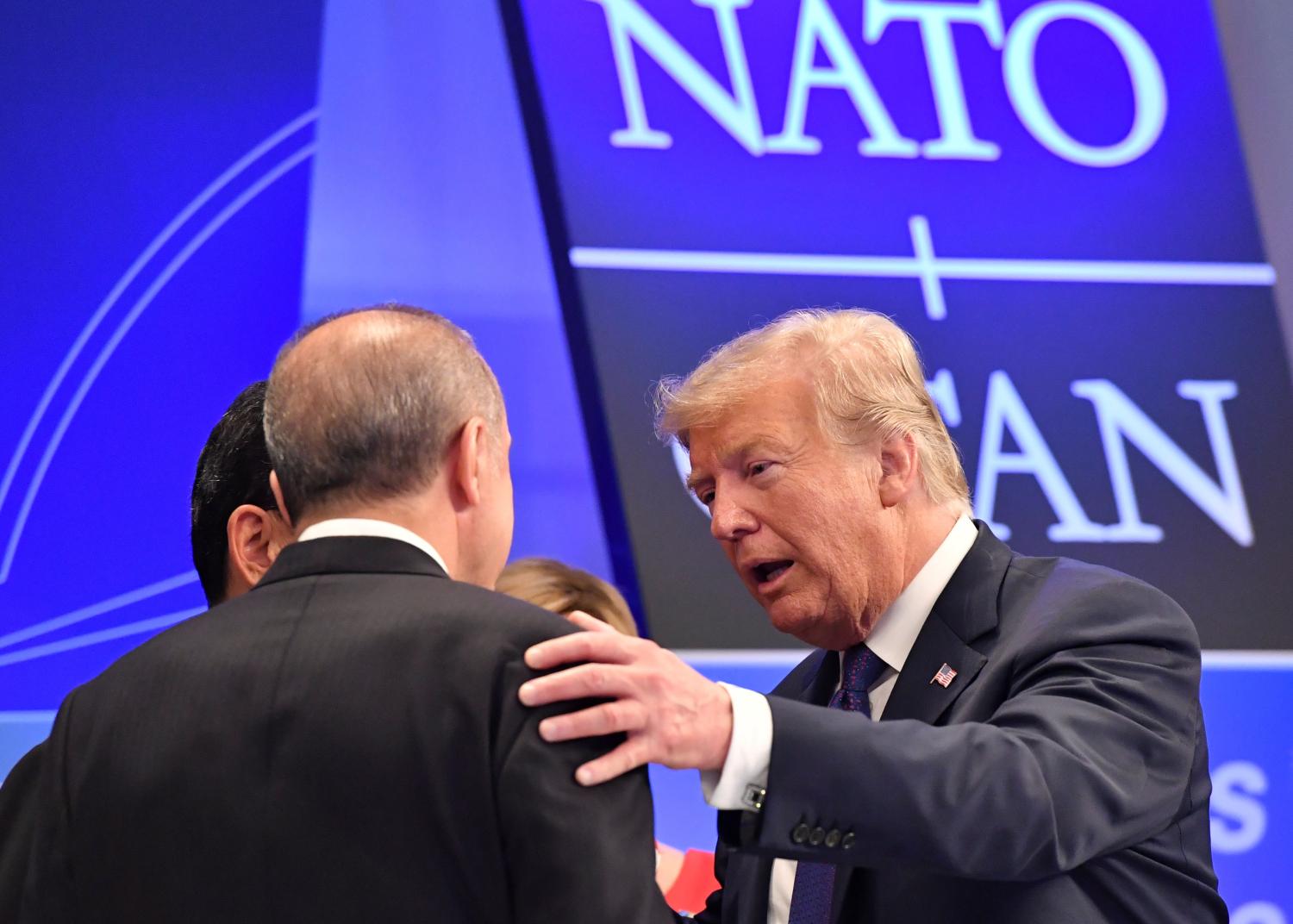 U.S. President Donald Trump talks to Turkish President Recep Tayyip Erdogan as they arrive for a dinner at the Art and History Museum at the Parc du Cinquantenaire during the NATO Summit in Brussels, Belgium July 11, 2018. Geert Vanden Wijngaert/Pool via REUTERS - RC1D6A6DA660