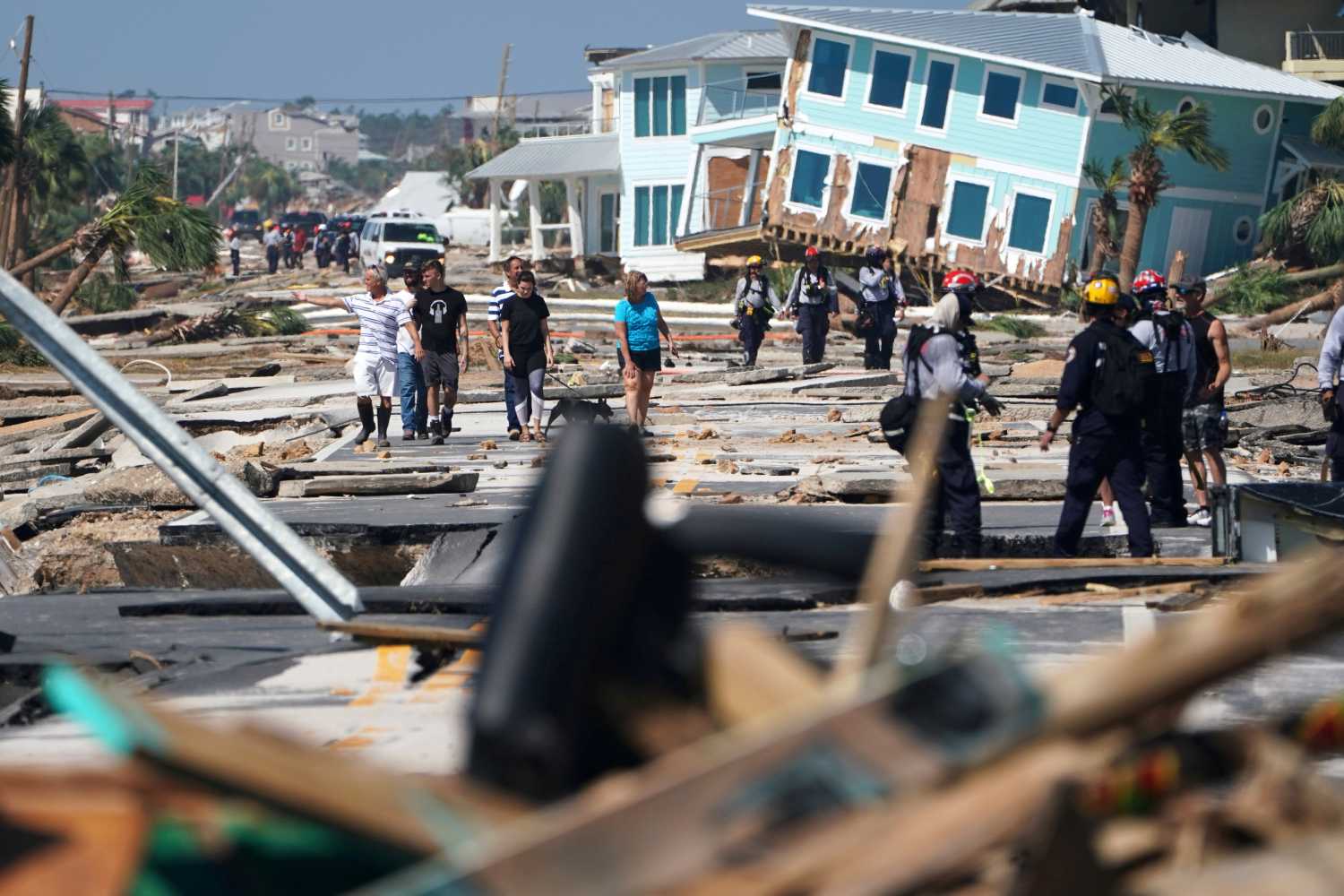 First responders and residents walk along a main street following Hurricane Michael in Mexico Beach, Florida, U.S., October 11, 2018. REUTERS/Carlo Allegri     TPX IMAGES OF THE DAY          TPX IMAGES OF THE DAY - RC18397C0100