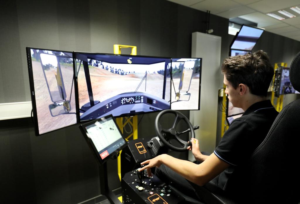 A student uses a driving simulator for civil engineering machines during a visit of the French President to The School of Application to the Trades of Public Works (EATP), which is devoted to apprenticeship and vocational training in Egletons, France, October 4, 2017.  REUTERS/Ludovic Marin/Pool - RC1A228984D0