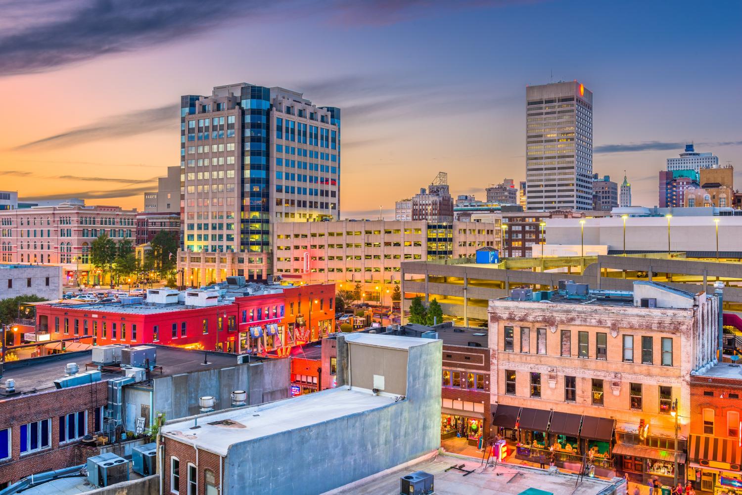 Memphis, Tennessee, USA city skyline over Beale Street at dusk.