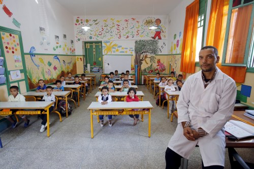 Teacher Moulay Ismael Lamrani poses for a picture with his class in the Oudaya primary school in Rabat, September 15, 2015, at the start of the new school year in Morocco. Nearly three years after Taliban gunmen shot Pakistani schoolgirl Malala Yousafzai, the teenage activist last week urged world leaders gathered in New York to help millions more children go to school. World Teachers' Day falls on 5 October, a Unesco initiative highlighting the work of educators struggling to teach children amid intimidation in Pakistan, conflict in Syria or poverty in Vietnam. Even so, there have been some improvements: the number of children not attending primary school has plummeted to an estimated 57 million worldwide in 2015, the U.N. says, down from 100 million 15 years ago. Reuters photographers have documented learning around the world, from well-resourced schools to pupils crammed into corridors in the Philippines, on boats in Brazil or in crowded classrooms in Burundi.    REUTERS/Youssef BoudlalPICTURE 41 OF 47 FOR WIDER IMAGE STORY "SCHOOLS AROUND THE WORLD"SEARCH "EDUCATORS SCHOOLS" FOR ALL IMAGES - GF10000226475