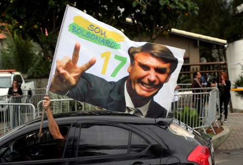 A supporter of Brazil's new president-elect, Jair Bolsonaro, celebrates in front of Bolsonaro's condominium at Barra da Tijuca neighborhood in Rio de Janeiro, Brazil October 29, 2018.   REUTERS/Sergio Moraes - RC165F6F3CD0