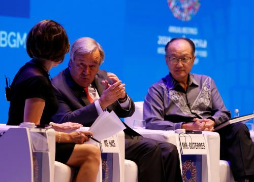 World Bank President Jim Yong Kim (R) and UN Secertary General Antonio Guterres (C) attend a seminar at International Monetary Fund - World Bank Annual Meeting 2018 in Nusa Dua, Bali, Indonesia, 13 October 2018. REUTERS/Johannes P. Christo - RC1709F00870