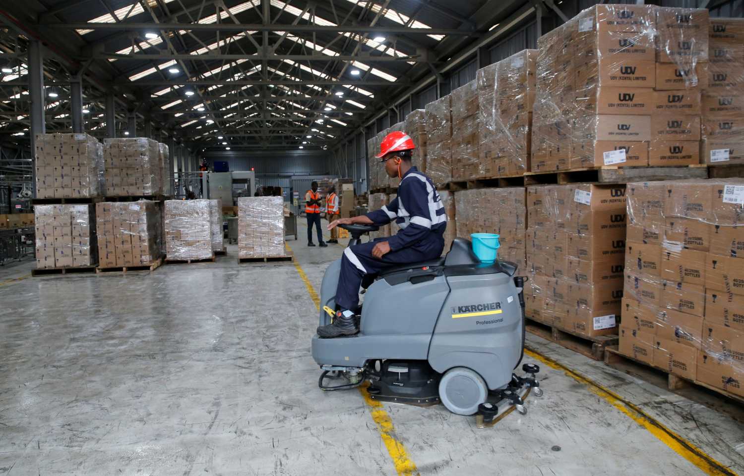 Employees work at the Kenya Cane spirit production line at the East African Breweries Limited factory in Ruaraka factory in Nairobi, Kenya April 6, 2018. Picture taken April 6, 2018. REUTERS/Thomas Mukoya - RC1A3A3D7320