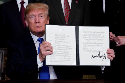 FILE PHOTO: FILE PHOTO: U.S. President Donald Trump holds his signed memorandum on intellectual property tariffs on high-tech goods from China, at the White House in Washington, U.S. March 22, 2018.  REUTERS/Jonathan Ernst/File Photo/File Photo - RC1E6BAE0250