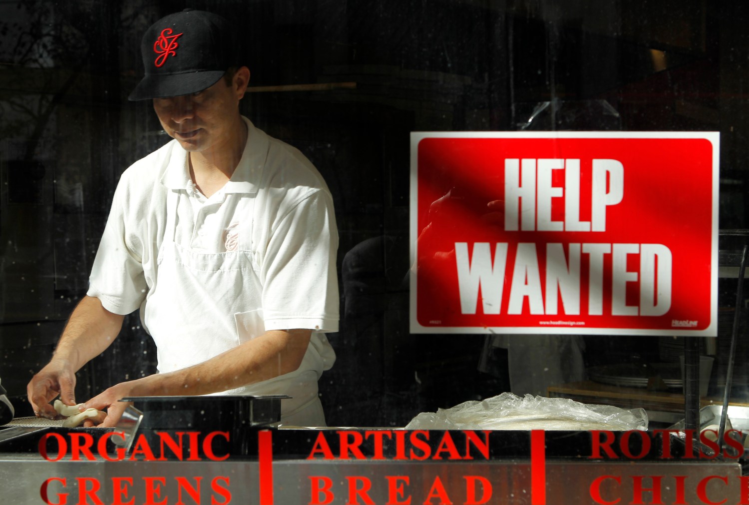 A man prepares a meal near a "help wanted" sign hanging in a restaurant window in San Francisco, California November 17, 2011.   REUTERS/Robert Galbraith  (UNITED STATES - Tags: BUSINESS EMPLOYMENT) - GM1E7BI0Y3E01