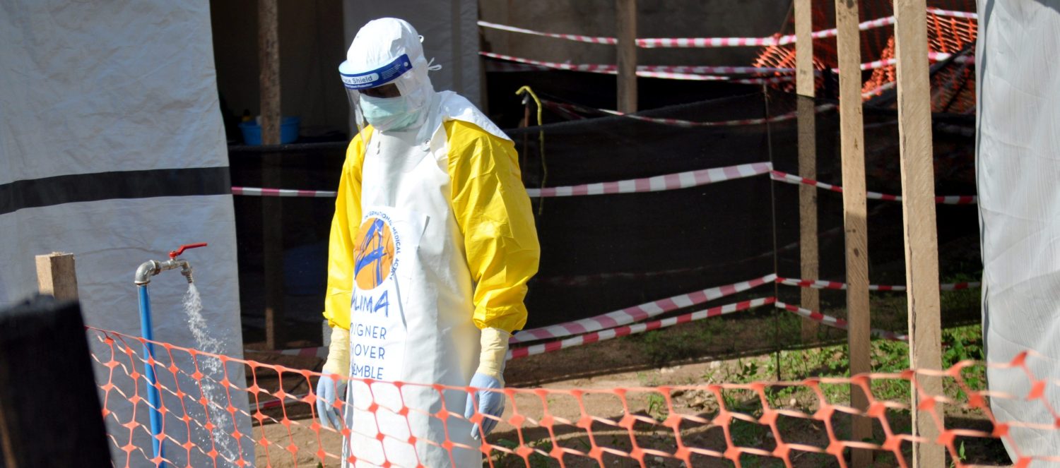 A medical worker wears a protective suit as he prepares to administer Ebola patient care.