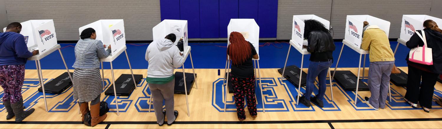 Citizens vote on a basketball court at a recreation center serving as polling place during the U.S. general election in Greenville, North Carolina, U.S. November 8, 2016.  REUTERS/Jonathan Drake - HT1ECB81QZBBW