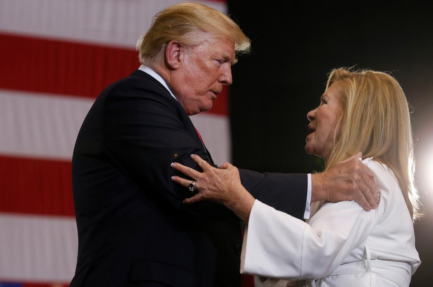 U.S. President Donald Trump greets Senate candidate Marsha Blackburn during a rally at Nashville Municipal Auditorium in Nashville, Tennessee, U.S., May 29, 2018. REUTERS/Leah Millis - RC173FDBA950