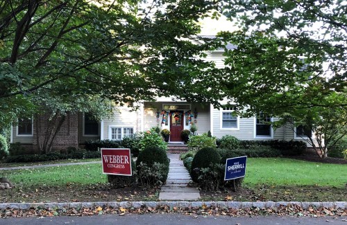 Election campaign signs of Republican candidate Jay Webber and Democrat candidate Mikie Sherrill are displayed on the front lawn of a house in New Jersey's 11th Congressional District, a midterm battleground, in Chatham, New Jersey, U.S., October 18, 2018.  REUTERS/Nancy Lapid - RC14B05FFC90
