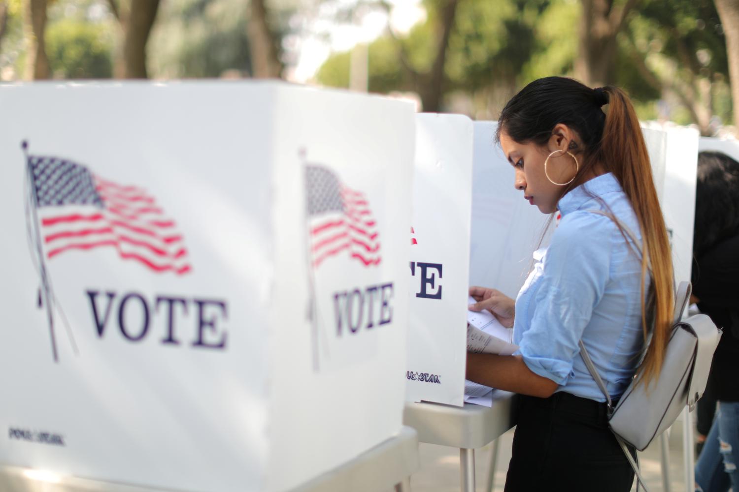 Desteny Martinez, 18, votes for the first time, in the U.S. congressional and gubernatorial midterm elections in Norwalk, California, United States, October 24, 2018. REUTERS/Lucy Nicholson - RC1BC2DECFC0