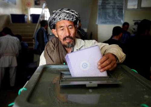 An Afghan man casts his vote during the parliamentary election at a polling station in Kabul, Afghanistan October 21, 2018. REUTERS/Omar Sobhani - RC1117B06270