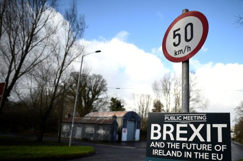 A former customs hut is seen behind a Brexit sign between Donegal in the Republic of Ireland and Londonderry in Northern Ireland at the border village of Muff, Ireland, February 1, 2018. Picture taken February 1, 2018. REUTERS/Clodagh Kilcoyne - RC1196063CD0