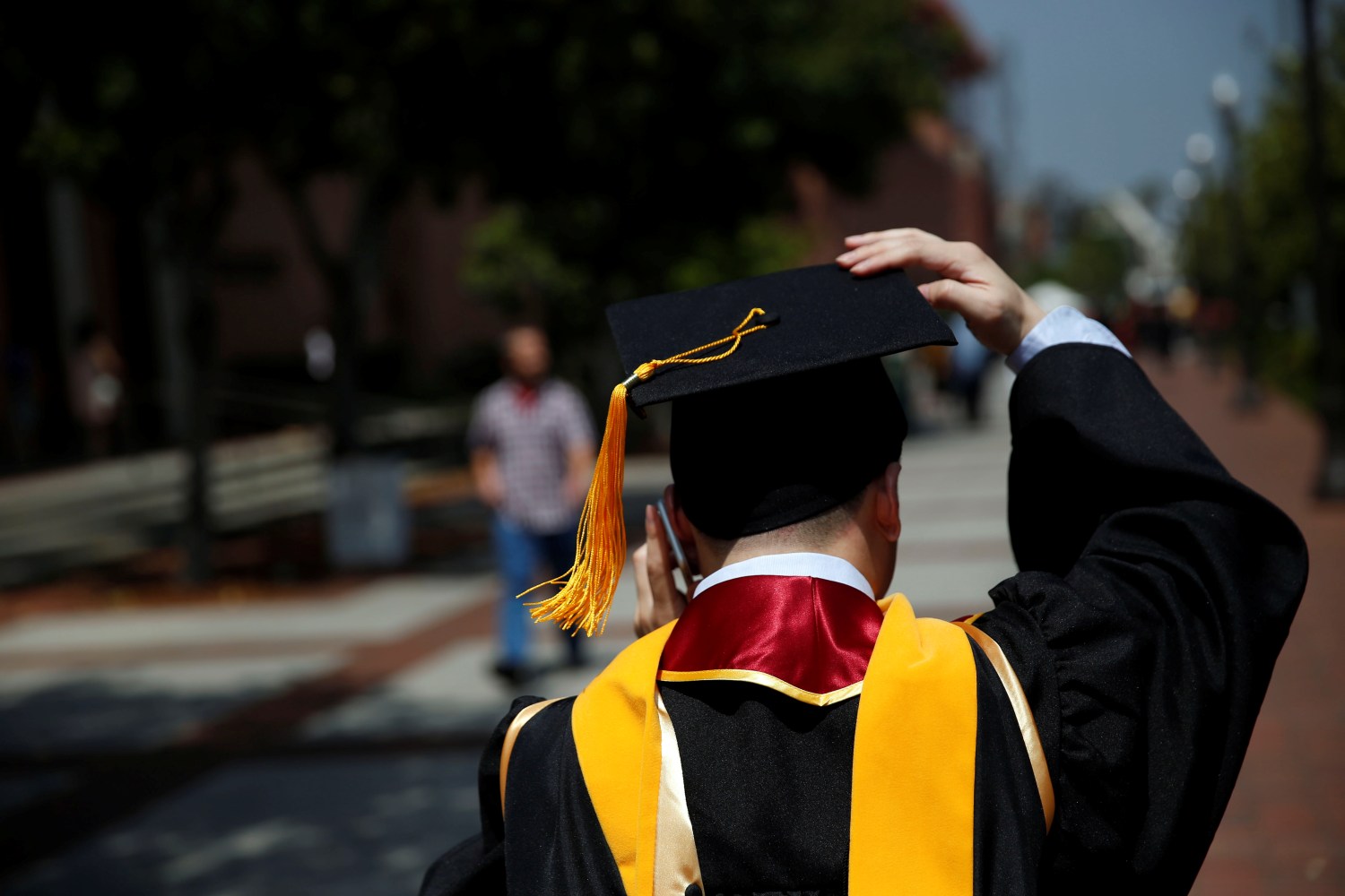 A graduate holds their mortarboard cap after a commencement ceremony at the University of Southern California (USC) in Los Angeles, California, U.S., May 12, 2017. REUTERS/Patrick T. Fallon - RC1D6F551E10